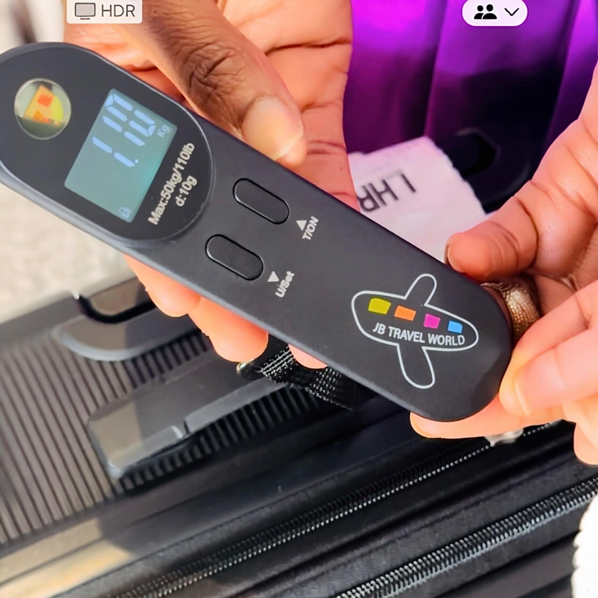 Traveler weighing suitcase with portable digital luggage scale to avoid excess baggage fees.