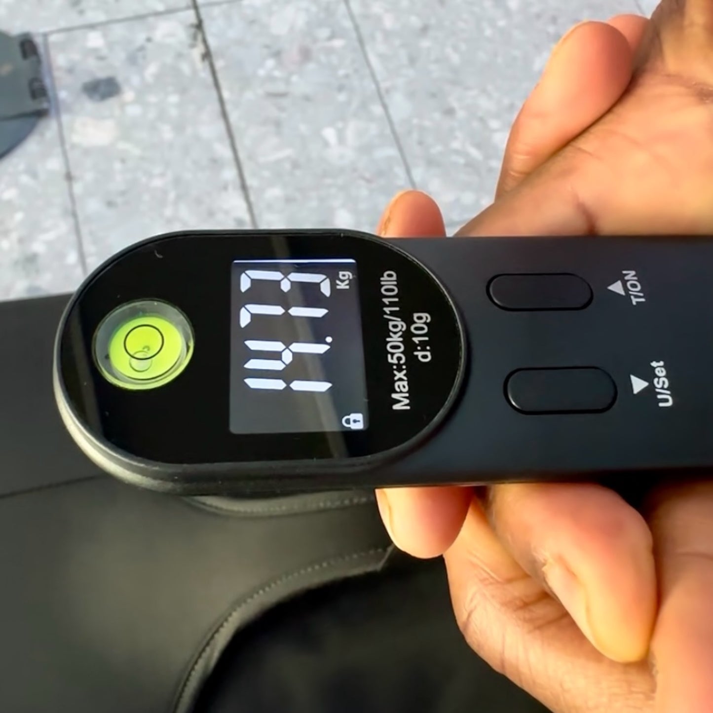 JB Travel World luggage scale weighing suitcase at airport
